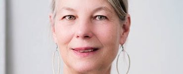 Woman with round earrings looking directly into the camera