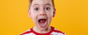 Close up portrait of a little boy screaming out loud